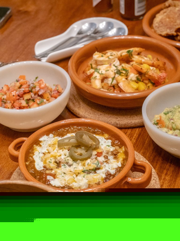 Food spread at 61 Orange with shrimp, chili con carne, and fresh accompaniments